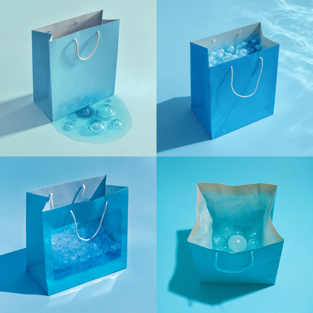 A blue paper shopping bag with a downward facing opening and a light blue bubble pool inside 