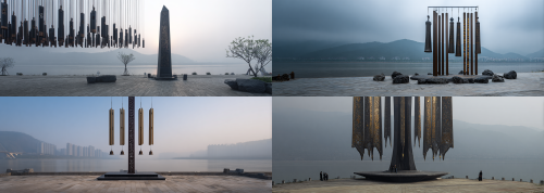 A monumental riverside wind chime landmark on the banks of the Yangtze River, seamlessly merging the ancient cultural symbolism of Chu-Han with contemporary public art. The central pillar, inspired by the legendary Sword of Goujian, ascends majestically like a sacred bronze totem—sharp, elegant, and exuding power, crafted from dark bronze with an exquisite aged patina and intricate gilded embellishments. Suspended from this grand structure are colossal wind chime elements, ingeniously derived from the forms and rhythmic arrangements of the Marquis Yi of Zeng’s Bianzhong bells, transformed into resplendent bronze chimes adorned with gilded edges, engraved patterns, and ancient ritual motifs, resonating with rich metallic tones. This captivating composition embodies the solemnity of Chu ritual music, the grandeur of Han cultural spirit, and the enigma of ancient Chinese bronze civilization. Nestled along the Yangtze waterfront, it is enveloped by a dramatic river landscape, shrouded in mist and wind, complemented by a stone plaza and expansive urban public space. A harmonious fusion of archaeology, ritual aesthetics, musical symbolism, and visionary cultural landmark design. Epic, majestic, elegant, rich in symbolism, realistic bronze material with gilded metal highlights, highly detailed, cinematic atmosphere, architectural concept rendering, world-class cultural installation.  --ar 84:30  --style raw  --iw 1.5